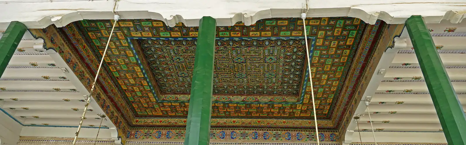 Painted and gilded wooden ceiling carried by green columns, in the Id Kah Mosque.